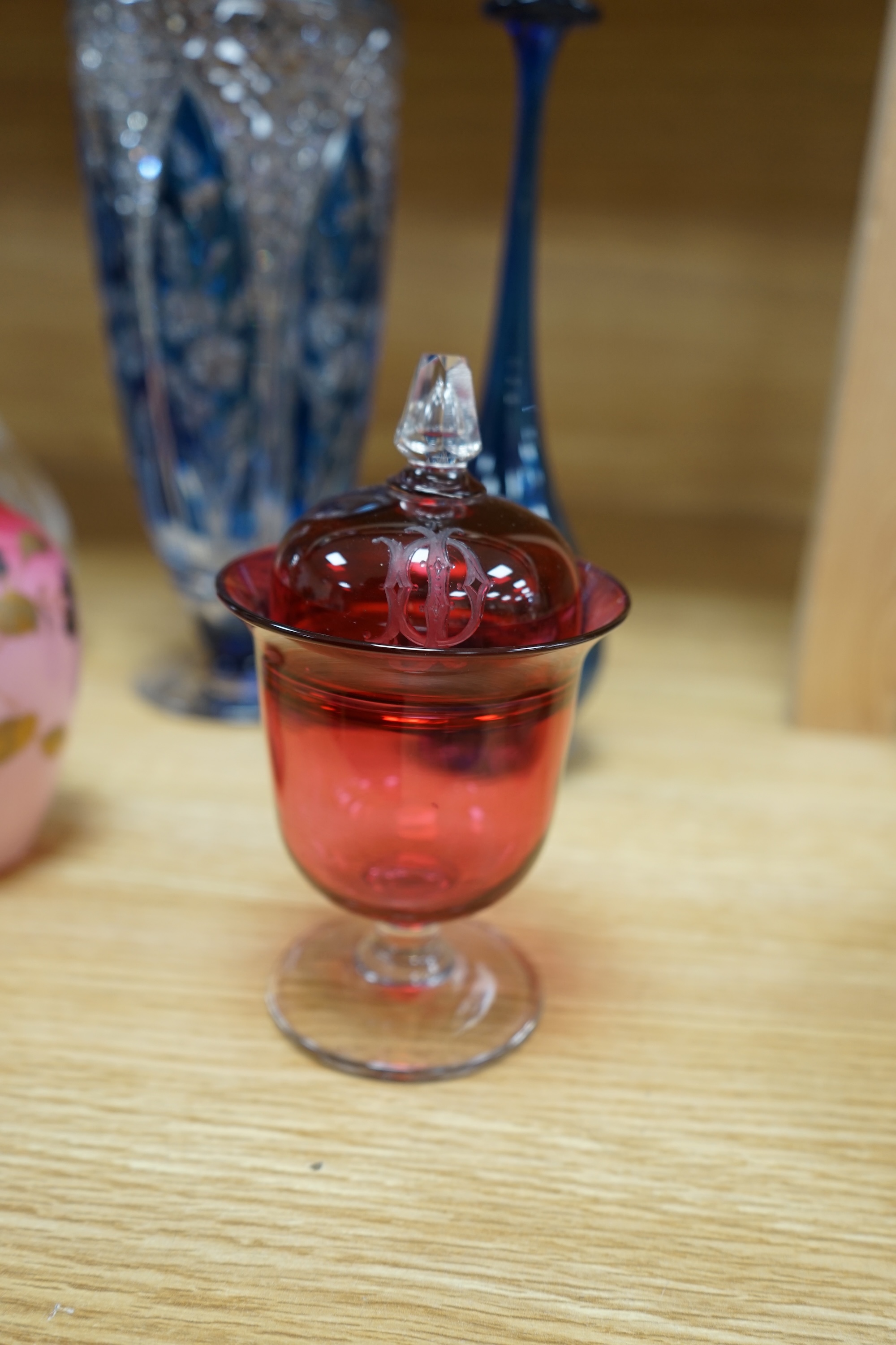 A collection of mixed 19th/20th century coloured glassware, to include a monogrammed cranberry bowl and plate, a flashed glass vase and a small opaque floral vase, largest 34cm high. Condition - fair to good